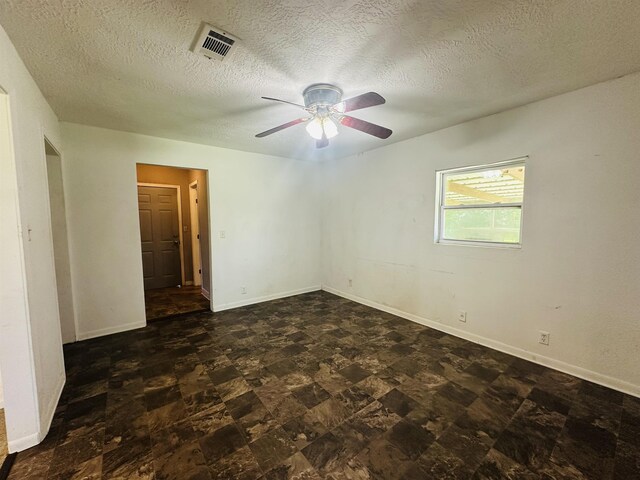 2922 Little Cypress Dr, Orange, TX 77632 - empty room with a ceiling fan, a textured ceiling, and baseboards