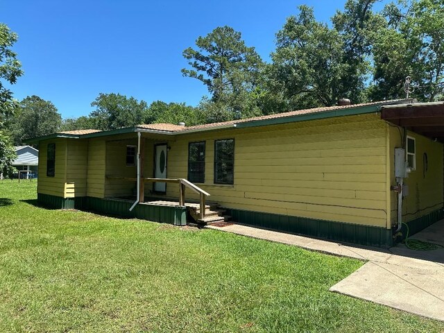 2922 Little Cypress Dr, Orange, TX 77632 - manufactured / mobile home featuring a front yard and metal roof