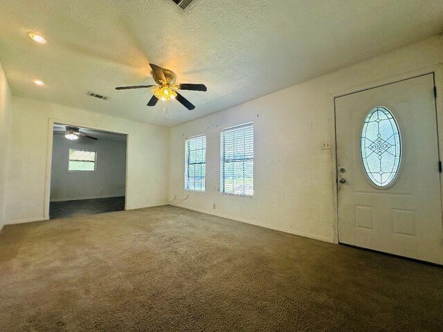 2922 Little Cypress Dr, Orange, TX 77632 - entrance foyer with plenty of natural light, a ceiling fan, carpet, a textured ceiling, and baseboards