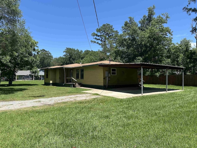 2922 Little Cypress Dr, Orange, TX 77632 - rear view of house featuring a carport