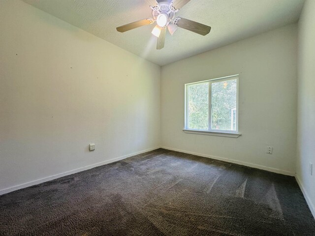 2922 Little Cypress Dr, Orange, TX 77632 - empty room featuring dark carpet, baseboards, and a ceiling fan