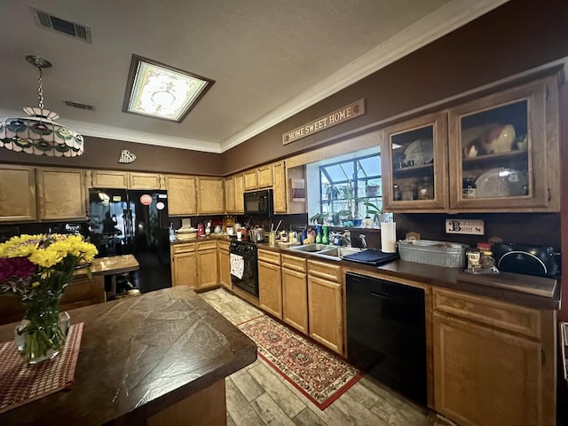 kitchen featuring black appliances, sink, ornamental molding, and light hardwood / wood-style flooring