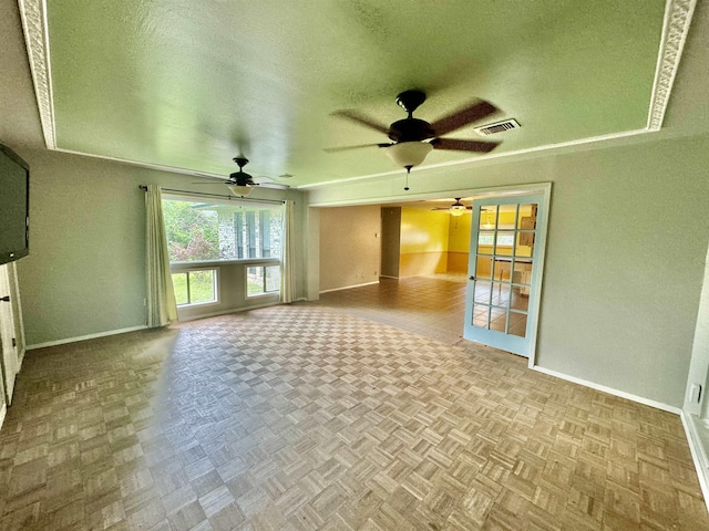 unfurnished living room with a textured ceiling and light parquet floors