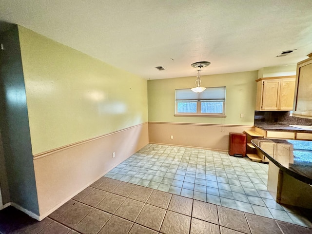 unfurnished dining area with light tile patterned floors and sink