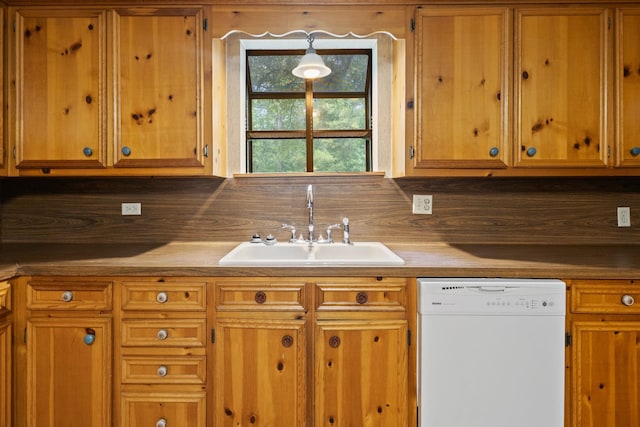 10425 Bussey Rd, Silsbee, TX 77656 - kitchen with white dishwasher and brown cabinetry