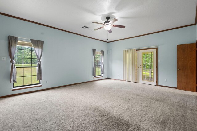 10425 Bussey Rd, Silsbee, TX 77656 - carpeted empty room with ornamental molding, ceiling fan, and plenty of natural light