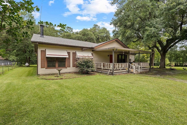 10425 Bussey Rd, Silsbee, TX 77656 - view of front of house featuring covered porch, a front yard, and a shingled roof