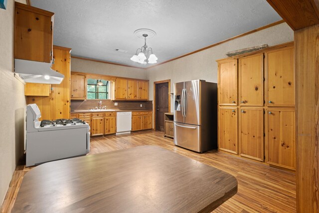 10425 Bussey Rd, Silsbee, TX 77656 - kitchen with white appliances, ventilation hood, ornamental molding, a chandelier, and light wood-style floors