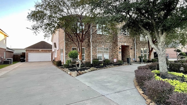 view of front of home with a garage and central AC