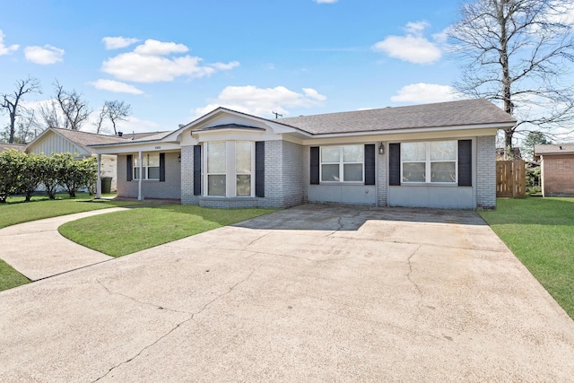 single story home featuring a front yard and brick siding