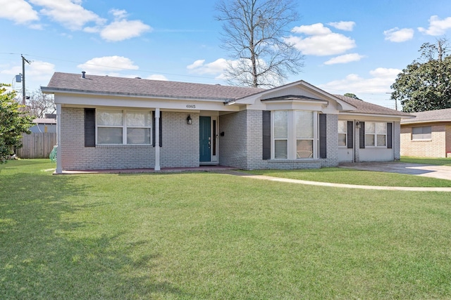 ranch-style house with a shingled roof, brick siding, fence, and a front lawn