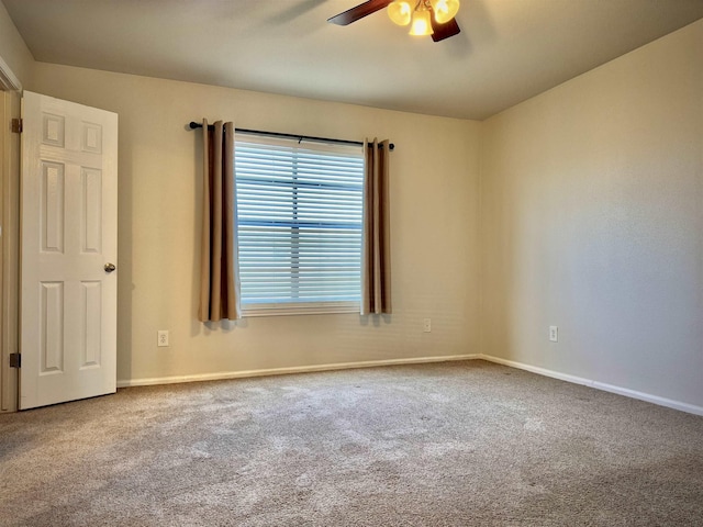 spare room featuring ceiling fan and carpet floors