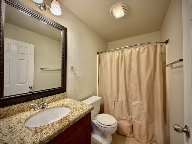 bathroom featuring vanity, toilet, and walk in shower