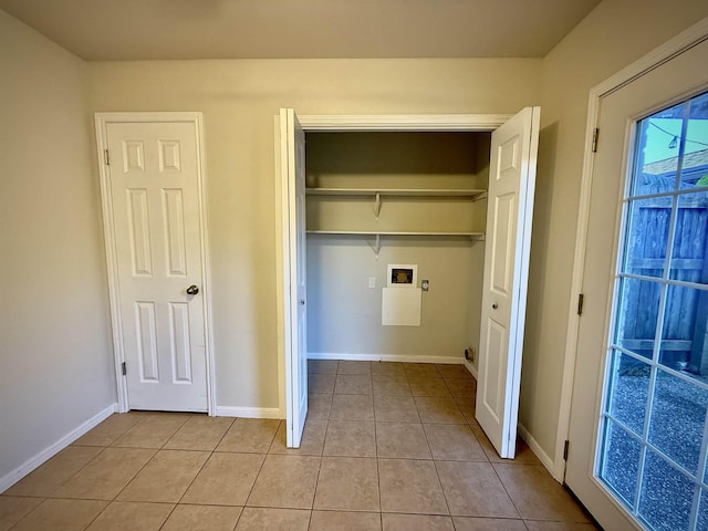 washroom with light tile patterned flooring and washer hookup