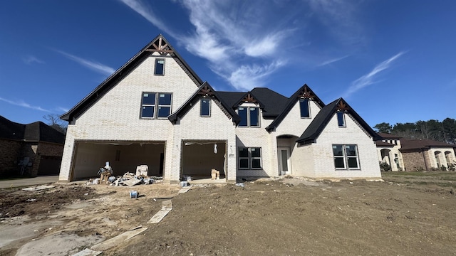 view of front of property featuring brick siding and a garage