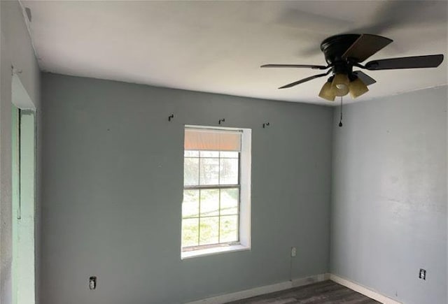 unfurnished room with dark hardwood / wood-style floors and ceiling fan