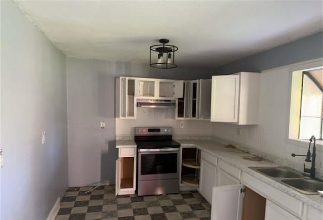 kitchen with white cabinetry, electric range, and sink