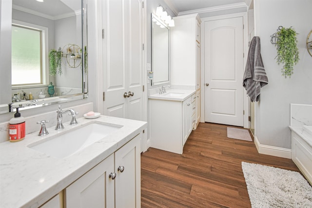 131 Oakdale, Silsbee, TX 77656 - full bath featuring crown molding, a sink, two vanities, and wood finished floors