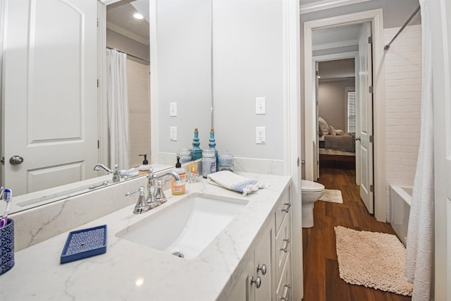 131 Oakdale, Silsbee, TX 77656 - full bathroom with recessed lighting, vanity, toilet, and wood finished floors
