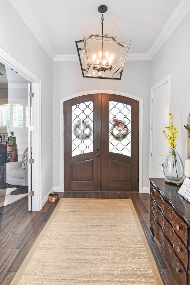 131 Oakdale, Silsbee, TX 77656 - foyer entrance featuring crown molding, dark wood finished floors, french doors, and an inviting chandelier