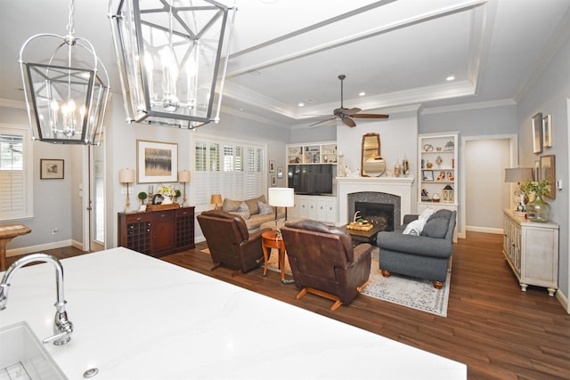 131 Oakdale, Silsbee, TX 77656 - bedroom with an inviting chandelier, multiple windows, a tray ceiling, and dark wood-type flooring