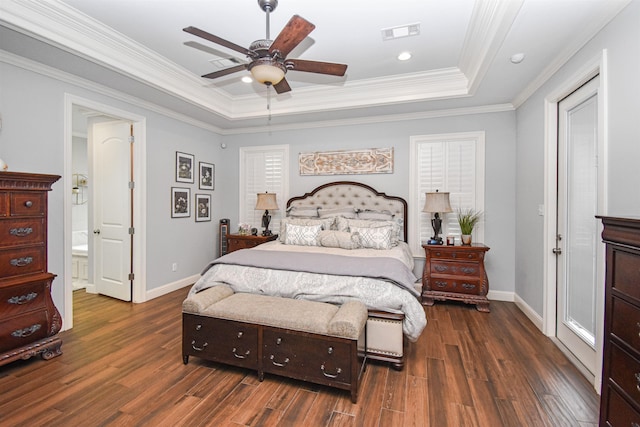 131 Oakdale, Silsbee, TX 77656 - bedroom with baseboards, a tray ceiling, dark wood-style floors, and visible vents