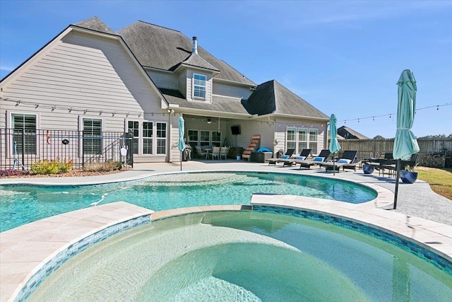 view of swimming pool featuring an in ground hot tub and a patio