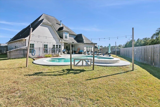 view of pool with a lawn and a patio