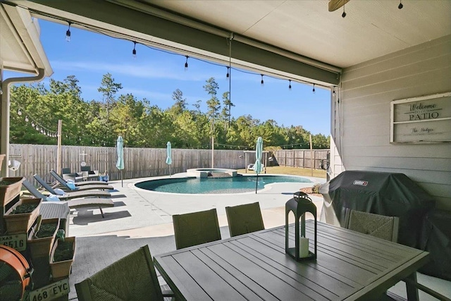 view of swimming pool featuring ceiling fan, area for grilling, a patio area, and an in ground hot tub