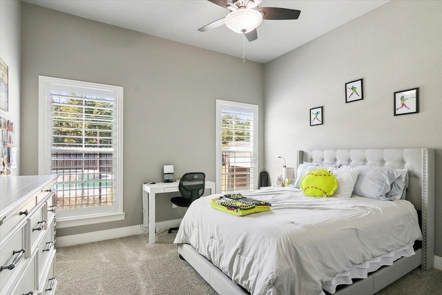 carpeted bedroom with ceiling fan and multiple windows