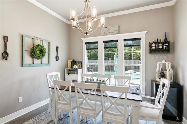 dining room featuring dark hardwood / wood-style floors, ornamental molding, and a chandelier