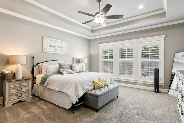 bedroom with a tray ceiling, ceiling fan, carpet flooring, and crown molding