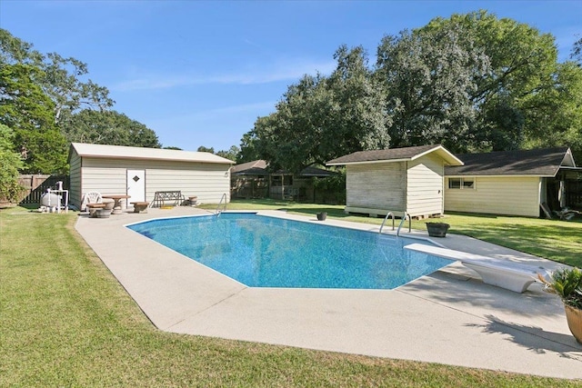 view of swimming pool with a diving board, a yard, a patio, and a shed