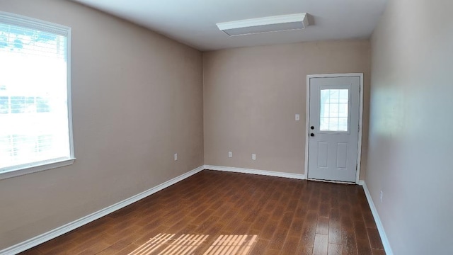 spare room with dark wood-type flooring