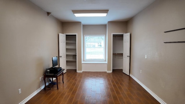 unfurnished bedroom featuring dark hardwood / wood-style floors