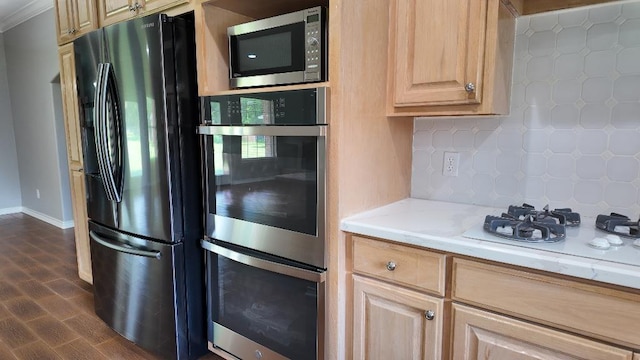 kitchen featuring appliances with stainless steel finishes, backsplash, dark wood-type flooring, and light brown cabinetry