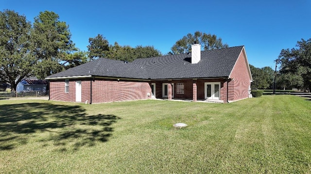 rear view of property featuring a yard