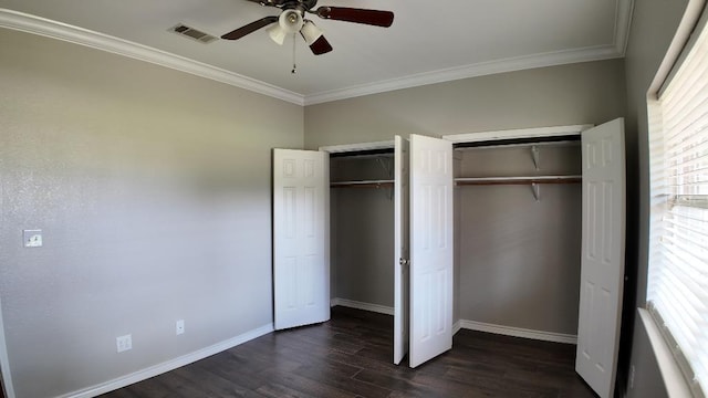 unfurnished bedroom with ceiling fan, crown molding, and dark wood-type flooring