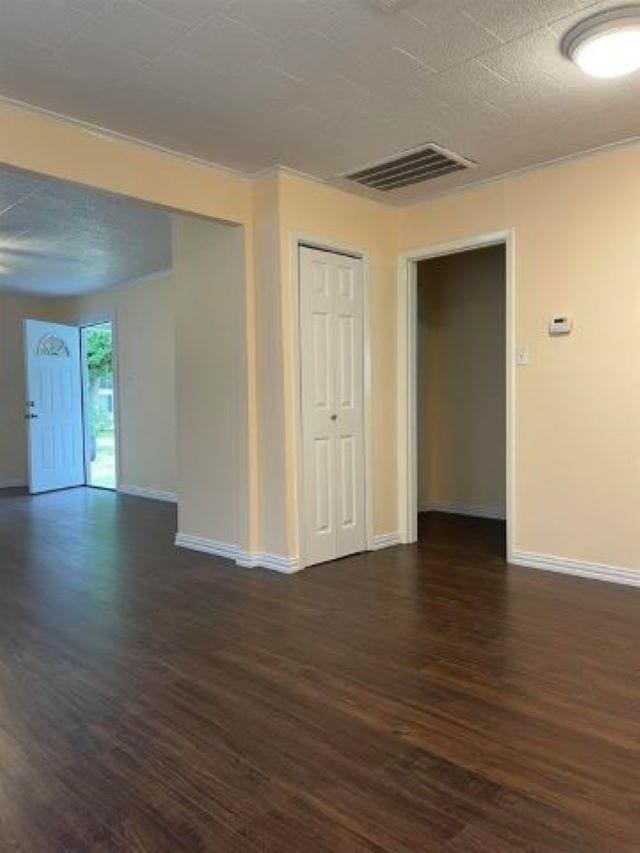 spare room featuring dark hardwood / wood-style flooring