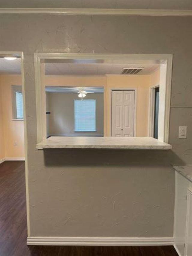 interior space with hardwood / wood-style floors and ornamental molding