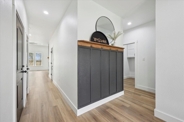 hallway featuring recessed lighting, baseboards, and wood finished floors