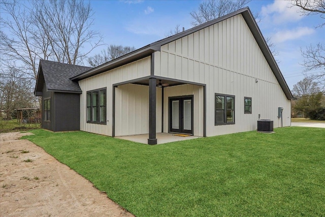 back of house featuring a patio, central AC unit, a yard, ceiling fan, and a shingled roof