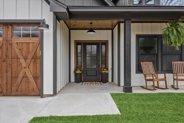 entrance to property featuring covered porch and board and batten siding