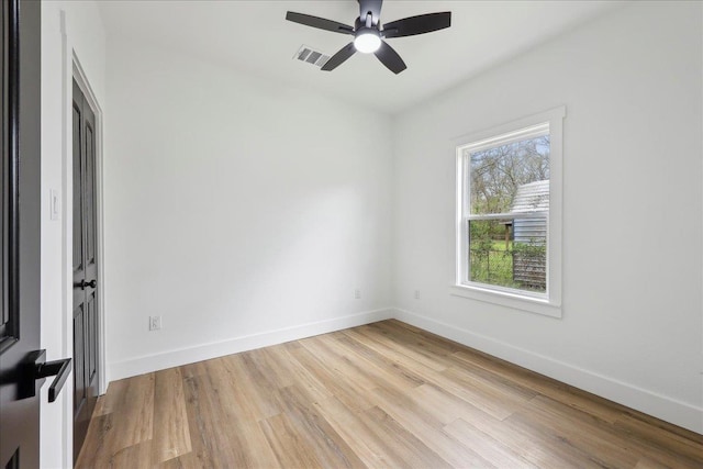 empty room featuring visible vents, ceiling fan, baseboards, and light wood-style floors