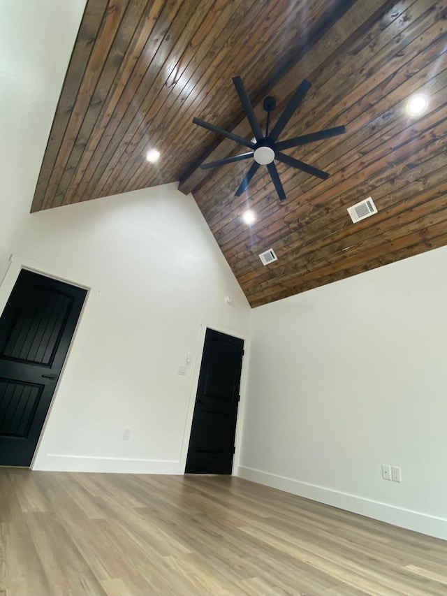 interior space with visible vents, high vaulted ceiling, baseboards, and wood finished floors