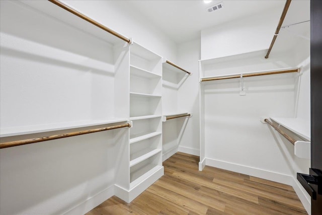 spacious closet with visible vents and wood finished floors