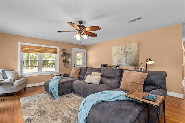 living room with wood-type flooring and ceiling fan