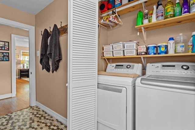 washroom with washing machine and clothes dryer