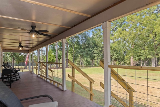 wooden deck with ceiling fan and a yard