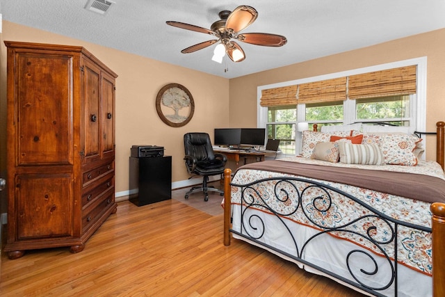 bedroom with light hardwood / wood-style flooring and ceiling fan